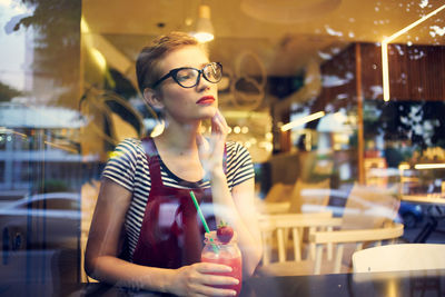 Young woman looking away at restaurant