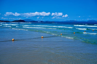 Scenic view of sea against blue sky