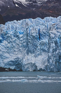 Scenic view of frozen sea against mountain