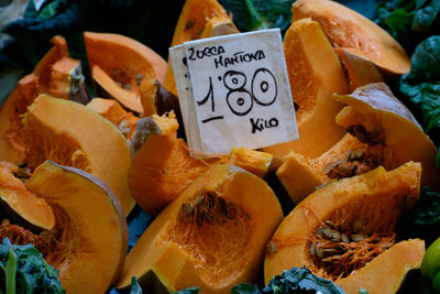 Halved pumpkins with price tag for sale at market stall