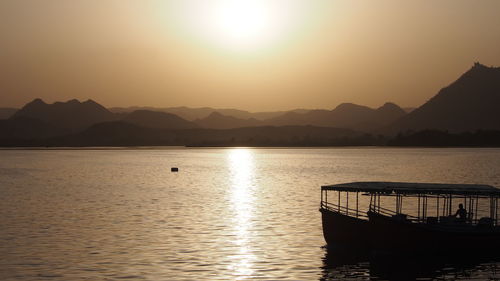 Scenic view of lake against sky during sunset