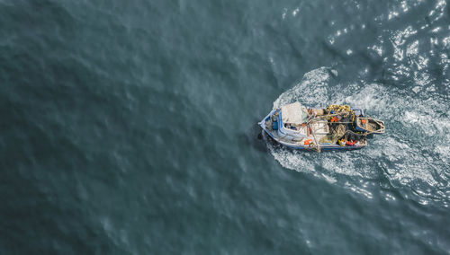 High angle view of people on boat in sea