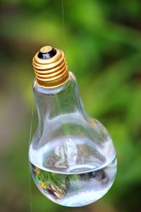 Close-up of light bulb on table