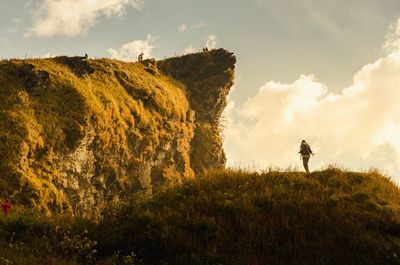 Panoramic view of man standing on field against sky