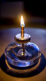 Close-up of illuminated lamp on table