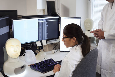 Student and teacher working with illuminated face model