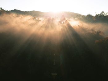 Sunlight streaming through clouds during sunset