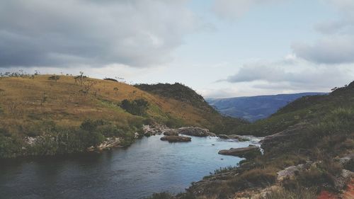 Scenic view of mountains against cloudy sky