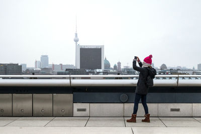 Rear view of woman standing on street