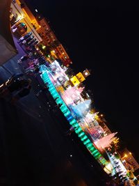 Low angle view of illuminated buildings against sky at night