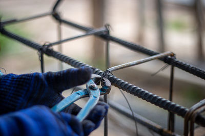 Cropped image of person holding rope