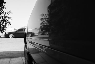 Cars on street against clear sky