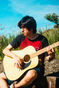 Young woman playing guitar