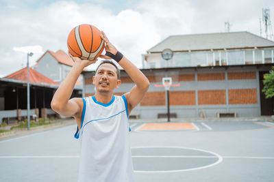 Man playing with ball on basketball court