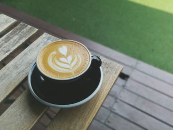 High angle view of frothy drink on wooden table