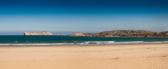 Scenic view of sea against blue sky