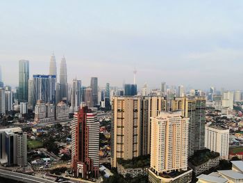 Aerial view of modern buildings in city against sky