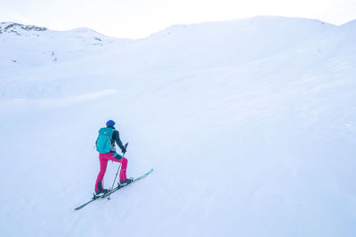 Woman tour skiing on snowcapped mountain