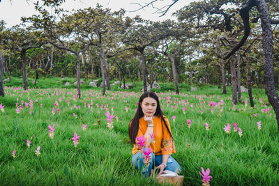 Portrait of beautiful young woman in flower field
