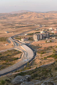 High angle view of road leading towards mountain against sky