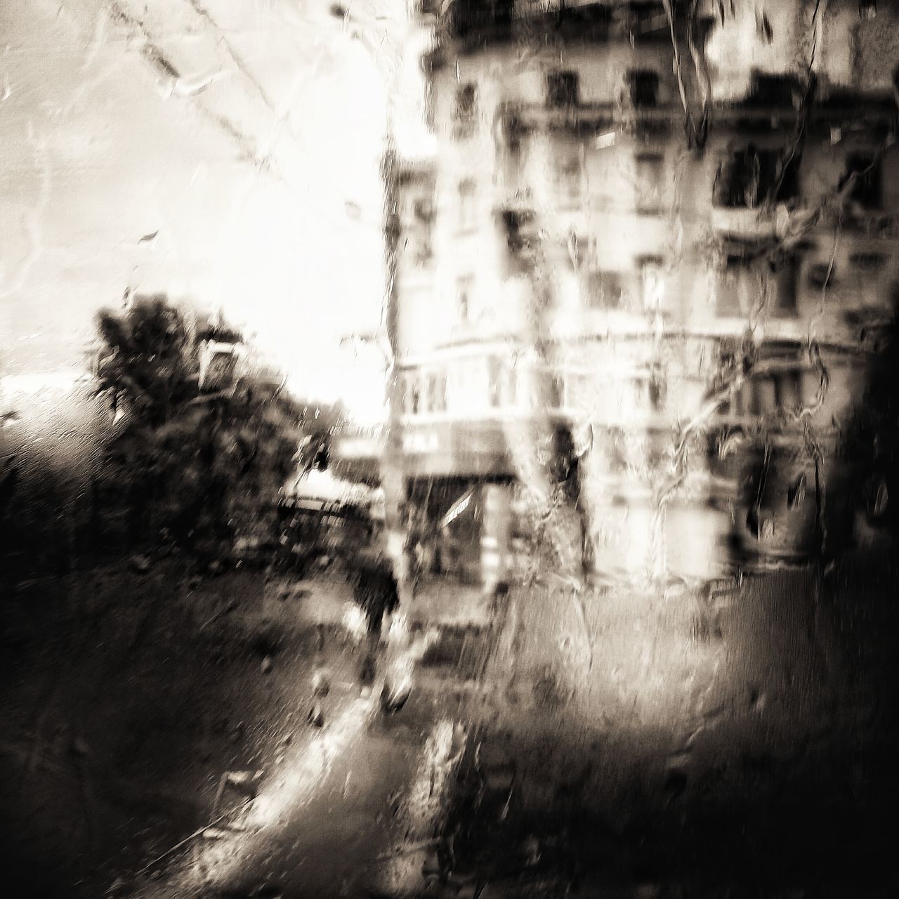 DEFOCUSED IMAGE OF RAIN ON WINDOW