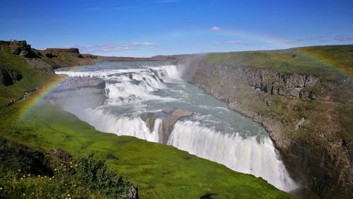 Scenic view of waterfall against sky