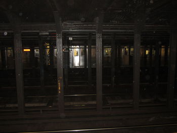 Illuminated railroad station platform at night