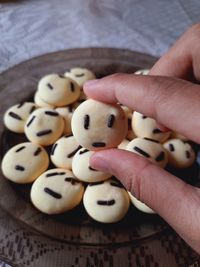 Close-up of hand holding egg biscuits or tamago boro