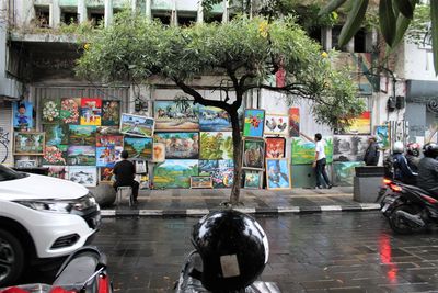 People on wet street in city