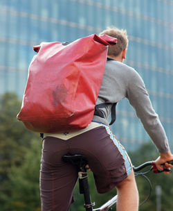 Rear view of man riding bicycle