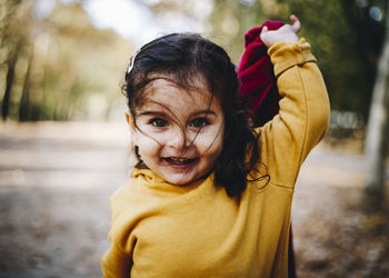 Portrait of smiling girl standing outdoors