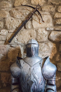 Close-up of old statue against wall