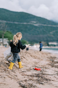 Full length of boy standing at beach