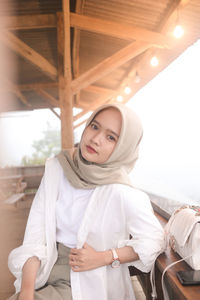 Portrait of young woman using mobile phone