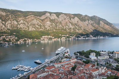 High angle view of townscape by lake against sky