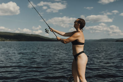 View of woman fishing