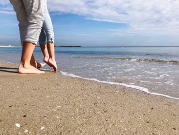 Low section of friends at beach