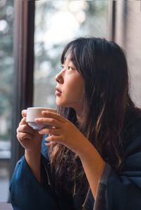 Woman having coffee at home