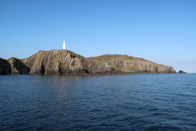 Scenic view of sea against clear blue sky