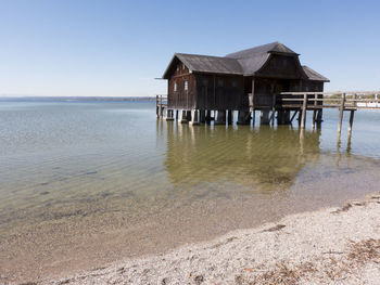 Built structure on beach against clear sky