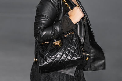 Midsection of man standing against white background