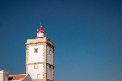 Low angle view of lighthouse against building