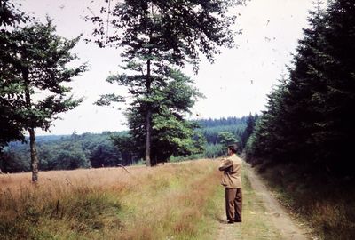 Rear view of man walking on field