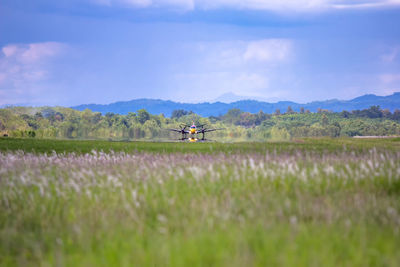 Air vehicle flying over lake against sky