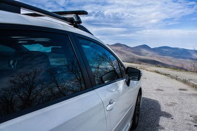 Close-up of car on mountain against sky