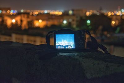 Close-up of illuminated lighting equipment in city at night