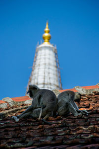 Low angle view of old building against clear blue sky