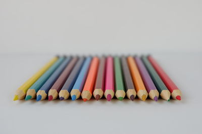 Close-up of colored pencils against white background