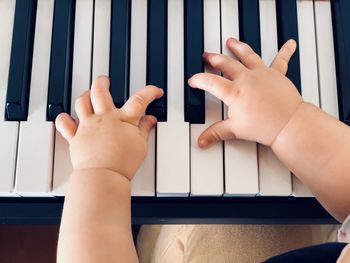 Close-up of hands playing piano