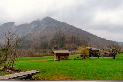 Built structure on field against sky